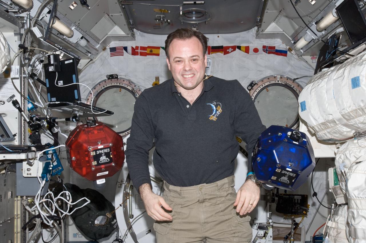 ISS028-E-023284 (8 Aug. 2011) --- NASA astronaut Ron Garan, Expedition 28 flight engineer, is pictured near two Synchronized Position Hold, Engage, Reorient, Experimental Satellites (SPHERES) floating freely in the Kibo laboratory of the International Space Station.
