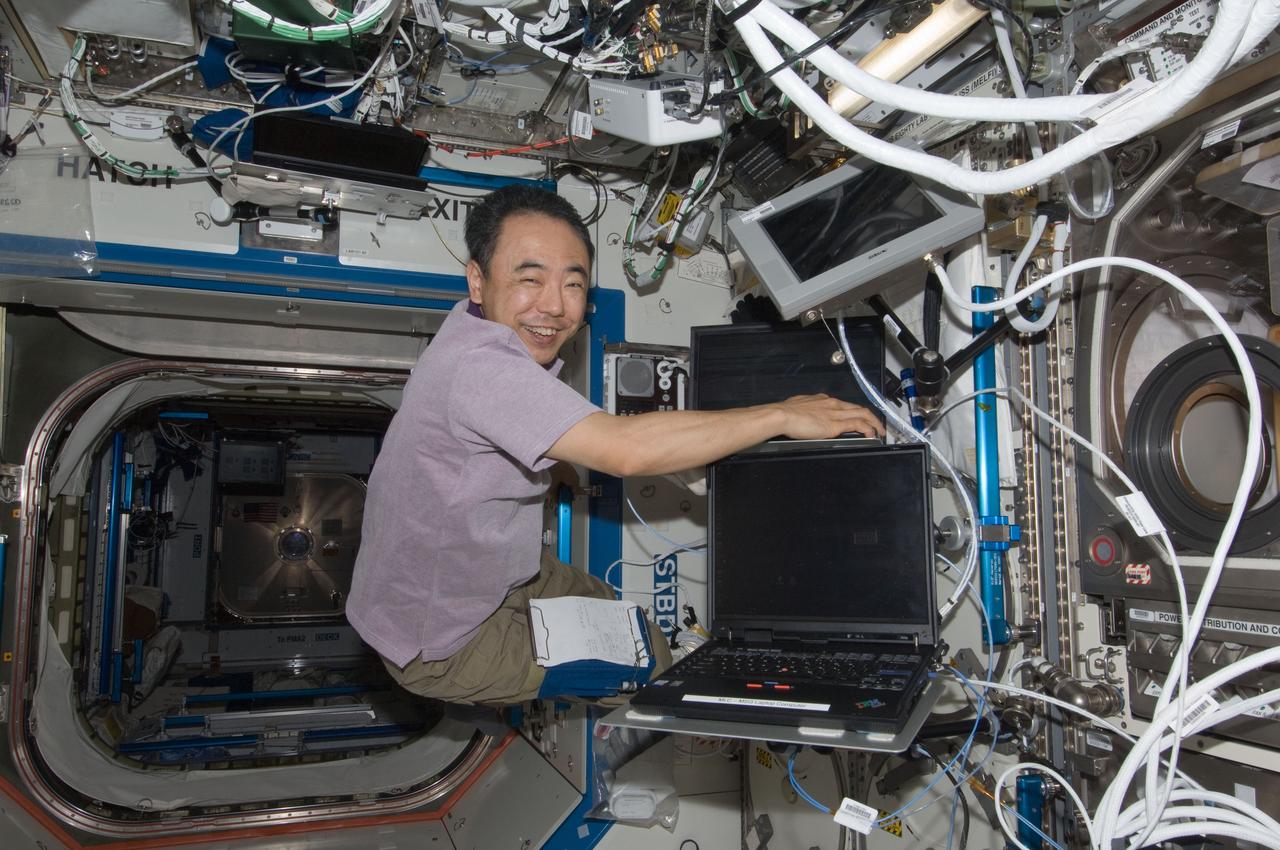 ISS028-E-025736 (15 Aug. 2011) --- Japan Aerospace Exploration Agency astronaut Satoshi Furukawa, Expedition 28 flight engineer, uses a computer to activate the Microgravity Science Glovebox (MSG) located in the Destiny laboratory of the International Space Station. Furukawa was preparing to conduct experiments with the Shear History Extensional Rheology Experiment (SHERE) hardware inside the MSG.