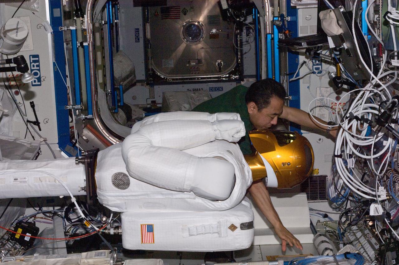ISS028-E-030086 (22 Aug. 2011) --- Japan Aerospace Exploration Agency astronaut Satoshi Furukawa and NASA astronaut Mike Fossum (out of frame), both Expedition 28 flight engineers, make preparations to power-up Robonaut 2 ? the first dexterous humanoid robot in space ? in the Destiny laboratory of the International Space Station.