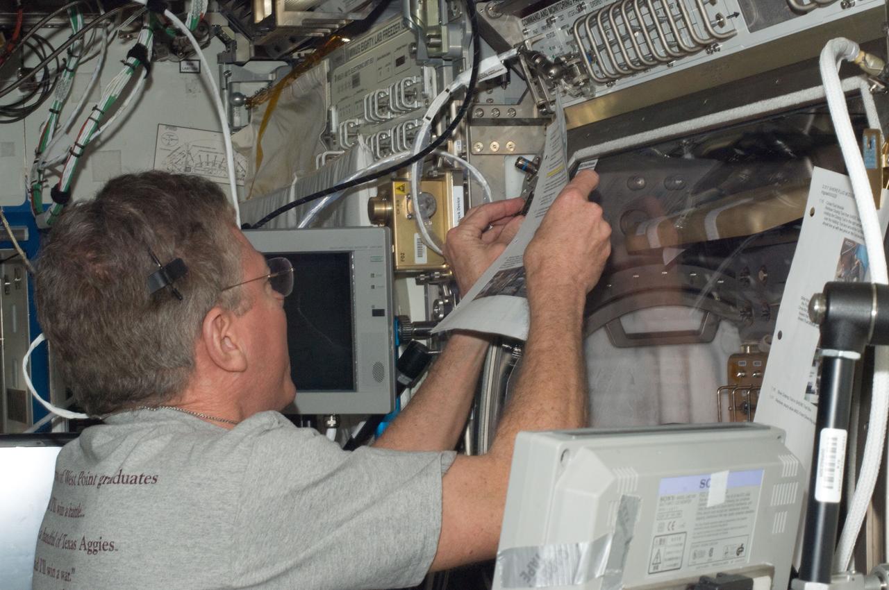 ISS028-E-031889 (20 Aug. 2011) --- NASA astronaut Mike Fossum, Expedition 28 flight engineer, works at the Microgravity Science Glovebox (MSG) located in the Destiny laboratory of the International Space Station.