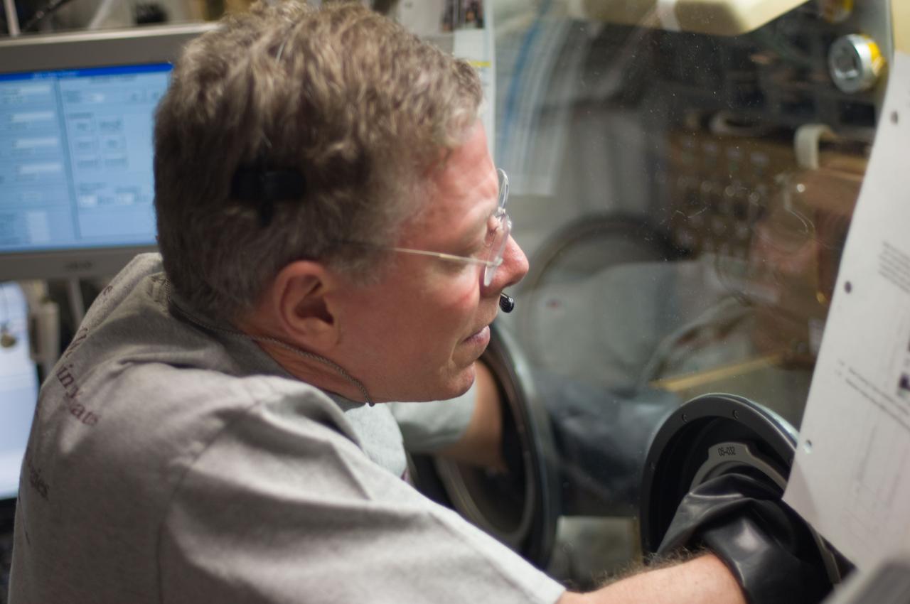 ISS028-E-031895 (20 Aug. 2011) --- NASA astronaut Mike Fossum, Expedition 28 flight engineer, works with hardware in the Microgravity Science Glovebox (MSG) located in the Destiny laboratory of the International Space Station.