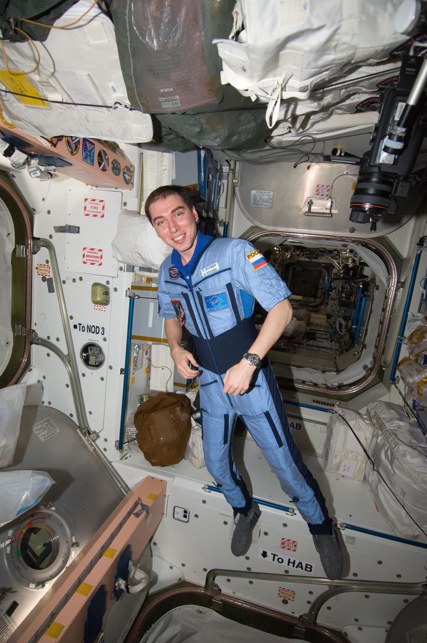 ISS028-E-032136 (17 Aug. 2011) --- Russian cosmonaut Sergei Volkov, Expedition 28 flight engineer, is pictured floating freely in the Unity node of the International Space Station while filming an installment of the ?The Orbital Station. Life on Orbit? video, intended for a documentary film to be prepared by the Roscosmos TV studio for the ?Kultura? State TV channel.