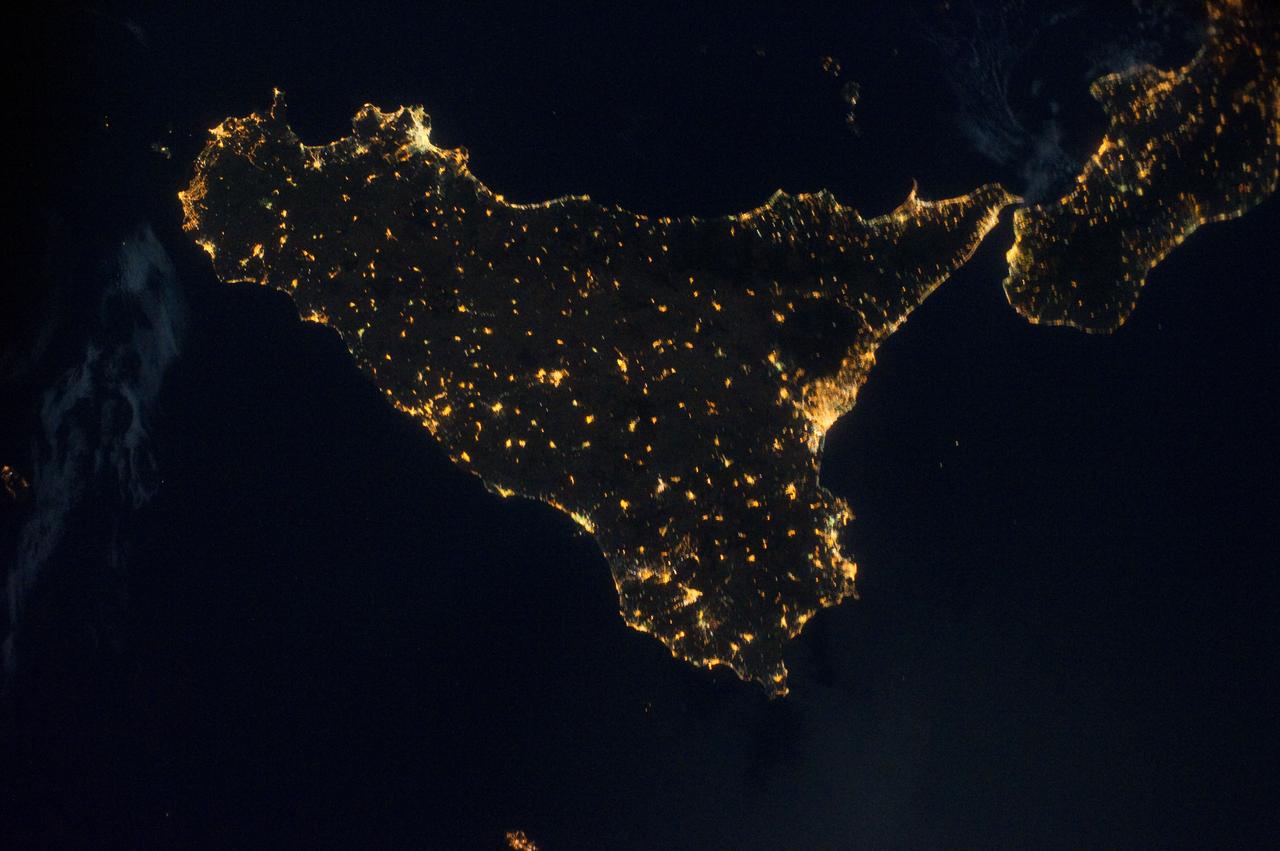ISS028-E-033099 (18 Aug. 2011) --- Sicily is featured in this night time image captured by one of the Expedition 28 crew members aboard the International Space Station, approximately 220 miles above Earth. The land mass in upper right corner is part of the "toe" of Italy's "boot." A 32-mm focal length was used to record the image.