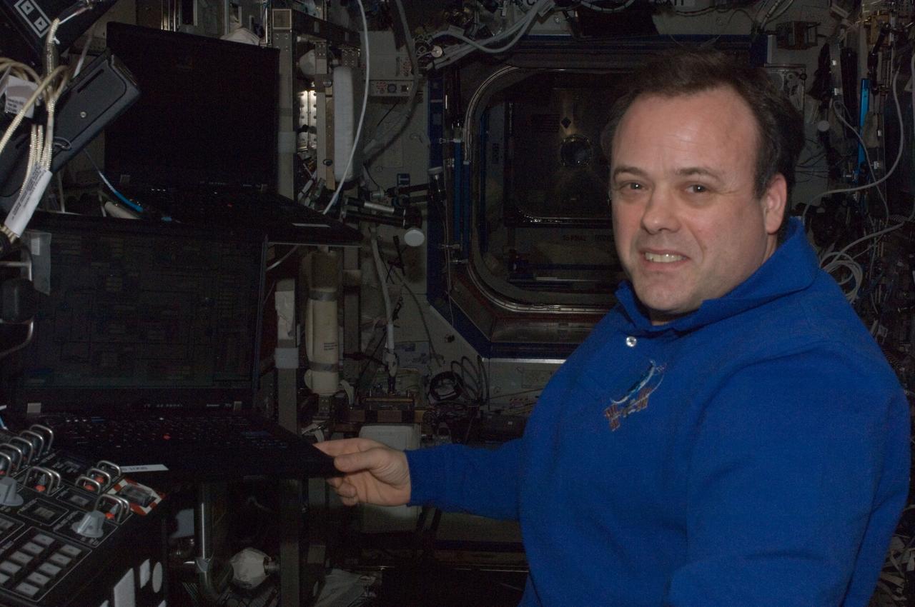 ISS028-E-034121 (26 Aug. 2011) --- NASA astronaut Ron Garan, Expedition 28 flight engineer, is pictured near a robotic workstation in the Destiny laboratory of the International Space Station.
