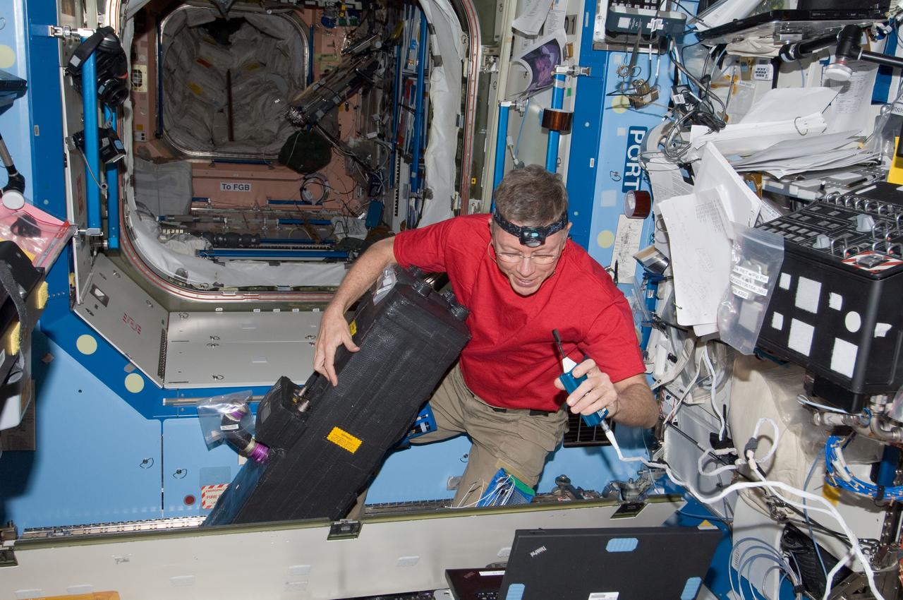 ISS028-E-034309 (25 Aug. 2011) --- NASA astronaut Mike Fossum, Expedition 28 flight engineer, performs in-flight maintenance on the Carbon Dioxide Removal Assembly (CDRA) located in the Destiny laboratory of the International Space Station.