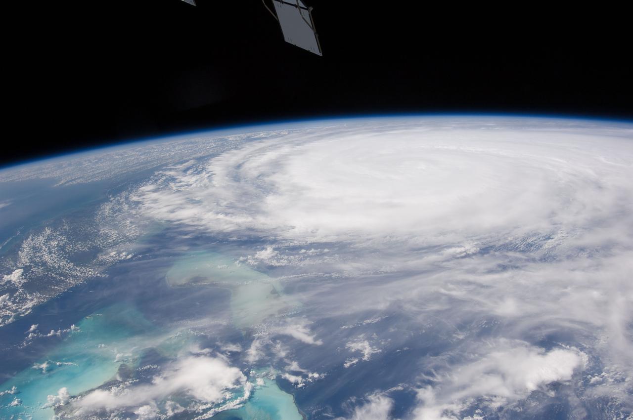 ISS028-E-034423 (26 Aug. 2011) --- This image of Hurricane Irene on Aug. 26 was photographed by one of the Expedition 28 crew members on board the International Space Station. The eye was at 31.2 degrees north latitude and 77.5 degrees west longitude moving due north 360 degrees at 14 miles per hour. Winds were 98 miles per hour, gusting to 120.8 miles per hour. Part of Florida's peninsula can be seen on the left and the northwest Bahamas are in lower left. One of the station?s trusses? radiator panels is at the upper center edge of the frame.