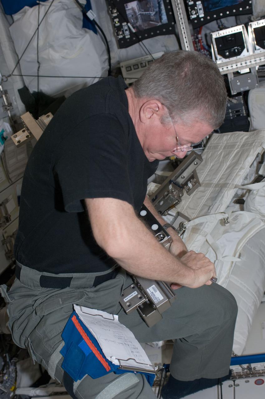ISS028-E-034978 (30 Aug. 2011) --- NASA astronaut Mike Fossum, Expedition 28 flight engineer, performs in-flight maintenance on the Muscle Atrophy Research & Exercise System (MARES) in the Columbus laboratory of the International Space Station.