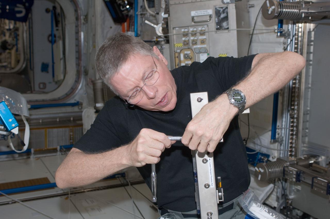 ISS028-E-034980 (30 Aug. 2011) --- NASA astronaut Mike Fossum, Expedition 28 flight engineer, performs in-flight maintenance on the Muscle Atrophy Research & Exercise System (MARES) in the Columbus laboratory of the International Space Station.