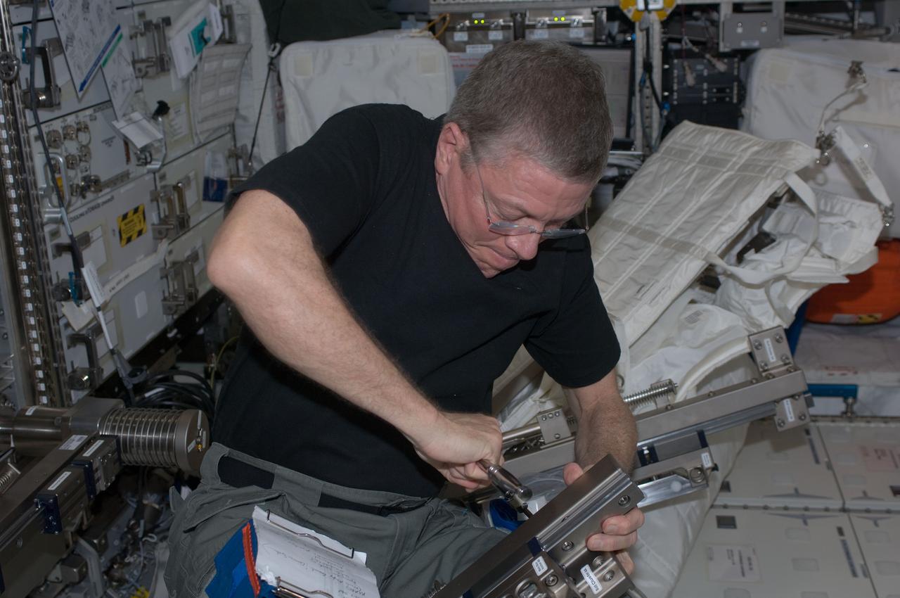 ISS028-E-034984 (30 Aug. 2011) --- NASA astronaut Mike Fossum, Expedition 28 flight engineer, performs in-flight maintenance on the Muscle Atrophy Research & Exercise System (MARES) in the Columbus laboratory of the International Space Station.