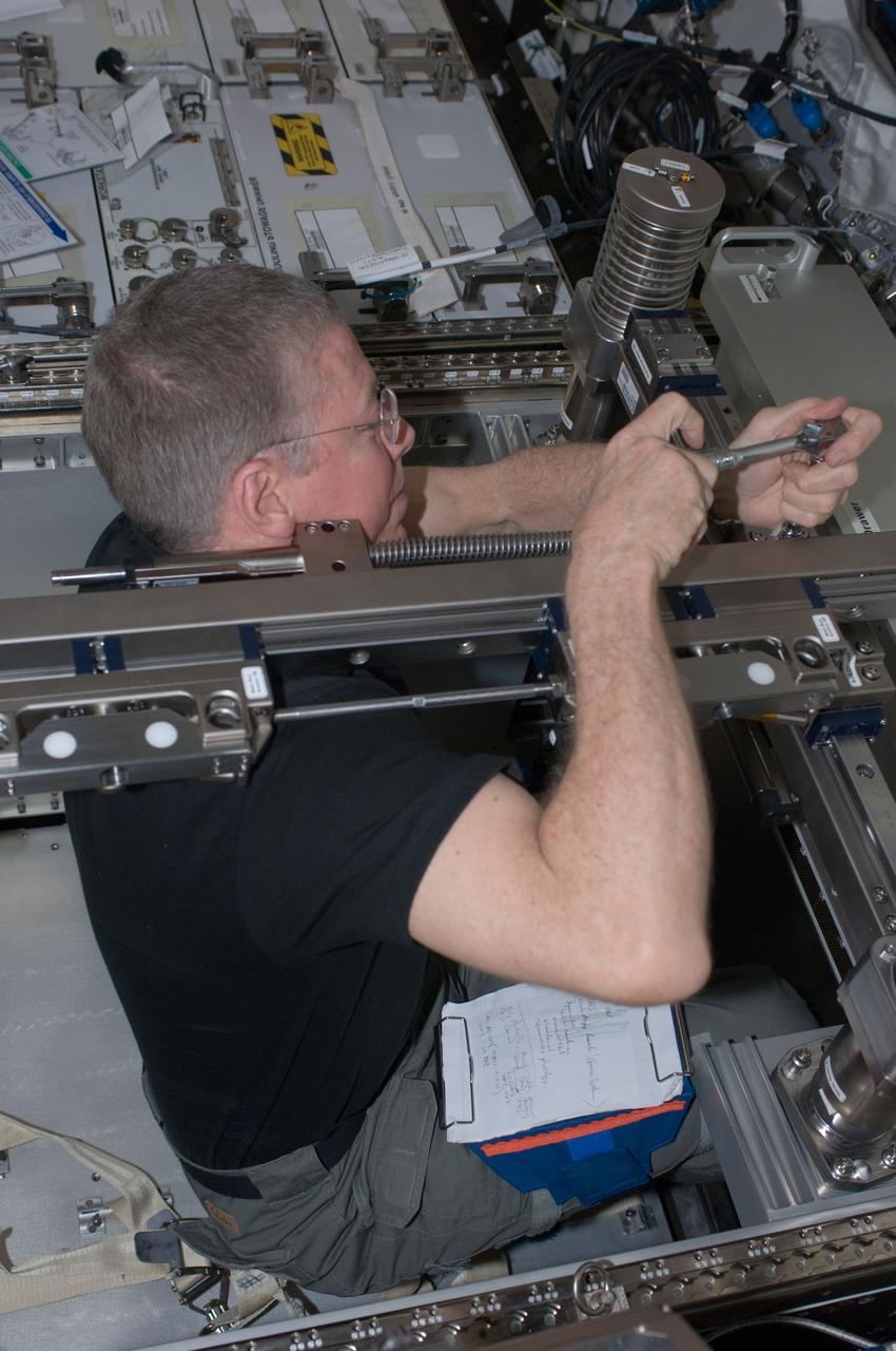 ISS028-E-034992 (30 Aug. 2011) --- NASA astronaut Mike Fossum, Expedition 28 flight engineer, performs in-flight maintenance on the Muscle Atrophy Research & Exercise System (MARES) in the Columbus laboratory of the International Space Station.