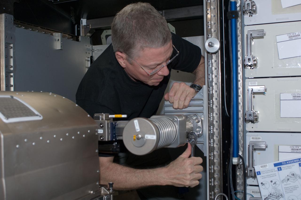 ISS028-E-035002 (30 Aug. 2011) --- NASA astronaut Mike Fossum, Expedition 28 flight engineer, performs in-flight maintenance on the Muscle Atrophy Research & Exercise System (MARES) in the Columbus laboratory of the International Space Station.