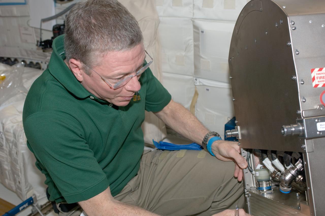 ISS028-E-035566 (31 Aug. 2011) --- NASA astronaut Mike Fossum, Expedition 28 flight engineer, works with Muscle Atrophy Research & Exercise System (MARES) hardware in the Columbus laboratory of the International Space Station.