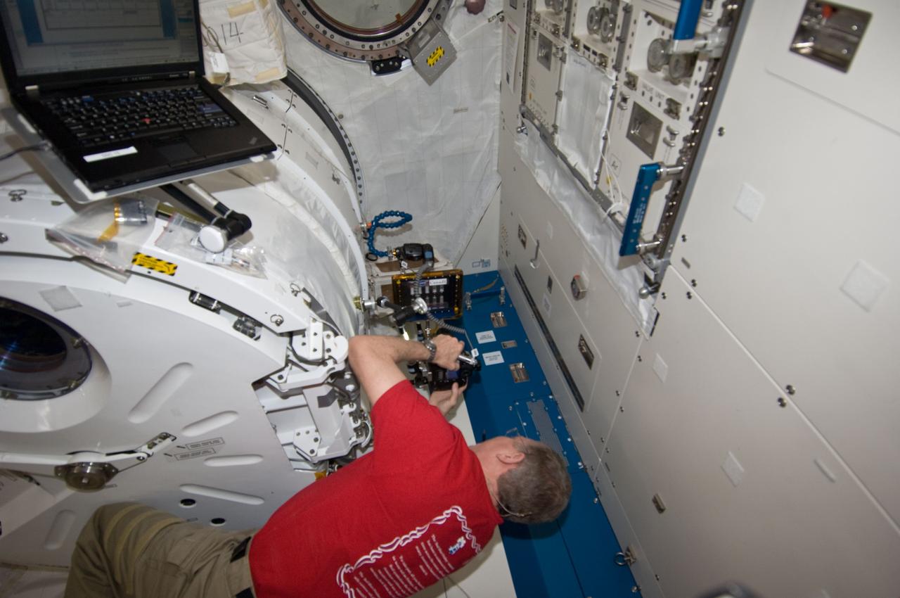 ISS028-E-036580 (2 Sept. 2011) --- NASA astronaut Mike Fossum, Expedition 28 flight engineer, conducts a session with the Binary Colloidal Alloy Test-5 (BCAT-5) in the Kibo laboratory of the International Space Station.