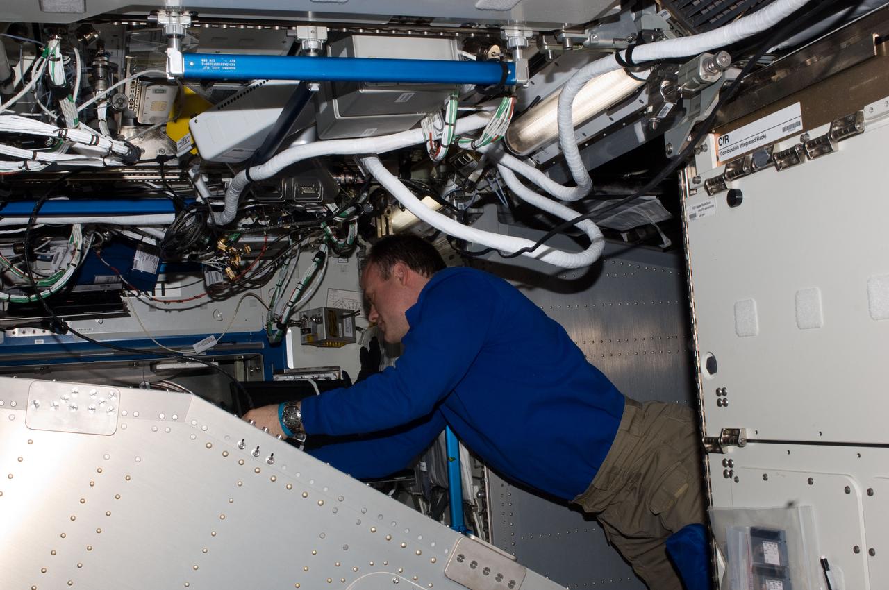 ISS028-E-047461 (12 Sept. 2011) --- NASA astronaut Ron Garan, Expedition 28 flight engineer, works behind the Microgravity Science Glovebox (MSG) rack located in the Destiny laboratory of the International Space Station.