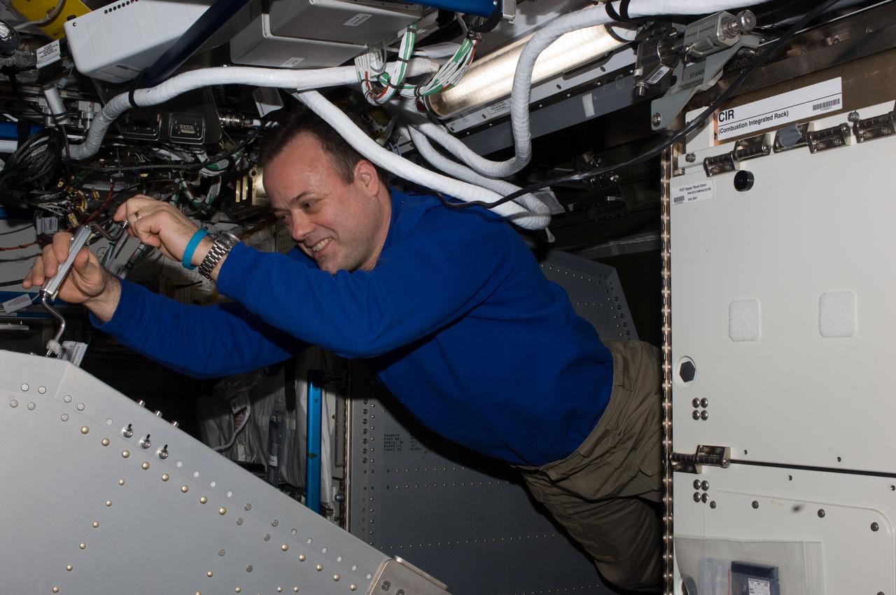 ISS028-E-047468 (12 Sept. 2011) --- NASA astronaut Ron Garan, Expedition 28 flight engineer, works behind the Microgravity Science Glovebox (MSG) rack located in the Destiny laboratory of the International Space Station.