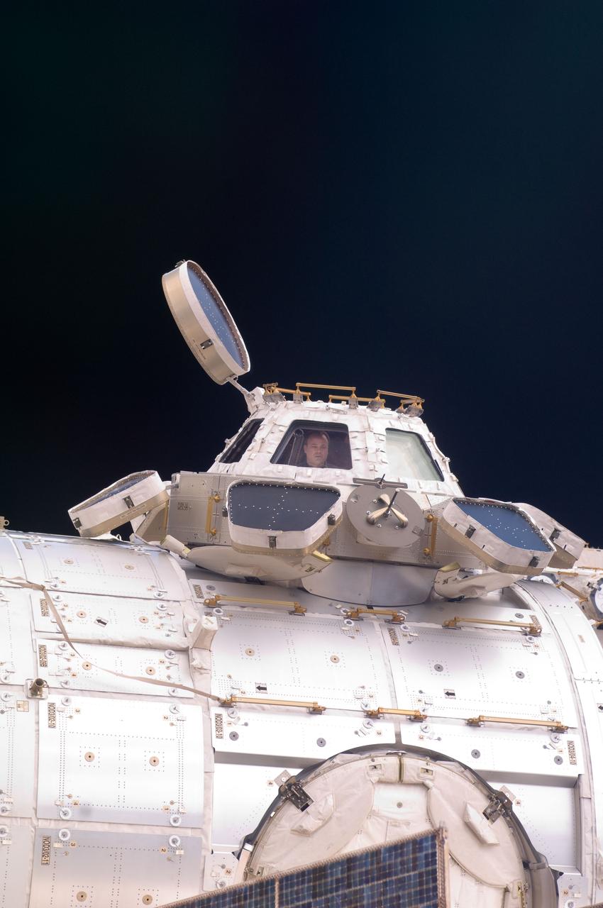 ISS028-E-048212 (11 Sept. 2011) --- Backdropped by the blackness of space, NASA astronaut Ron Garan, Expedition 28 flight engineer, is pictured in a window of the Cupola of the International Space Station.