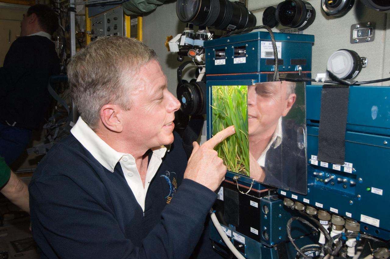 ISS028-E-050058 (15 Sept. 2011) --- NASA astronaut Mike Fossum, Expedition 28 flight engineer, inspects a new growth experiment on the BIO-5 Rasteniya-2 (Plants-2) payload with its LADA-01 greenhouse in the Zvezda Service Module of the International Space Station.
