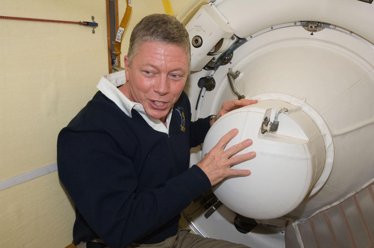 ISS028-E-050148 (15 Sept. 2011) --- NASA astronaut Mike Fossum, Expedition 29 commander, closes the Poisk Mini-Research Module 2 (MRM2) hatch in preparation of the departure of the Expedition 28 crew members on the Soyuz TMA-21 spacecraft.