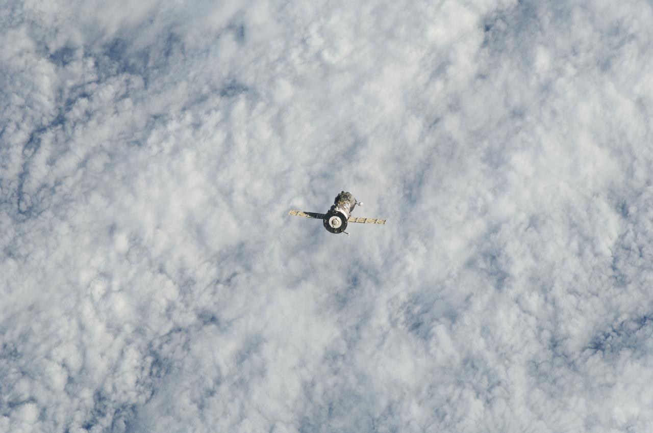 ISS029-E-005026 (16 Sept. 2011) --- Backdropped against clouds, the Soyuz TMA-21 spacecraft departs from the International Space Station and heads toward a landing in a remote area outside the town of Zhezkazgan, Kazakhstan, on Sept. 16, 2011. NASA astronaut Ron Garan, flight engineer, along with Expedition 28 commander Andrey Borisenko and flight engineer Alexander Samokutyaev, both of the Russian Federal Space Agency, are returning from more than five months onboard the International Space Station where they served as members of the Expedition 27 and 28 crews.
