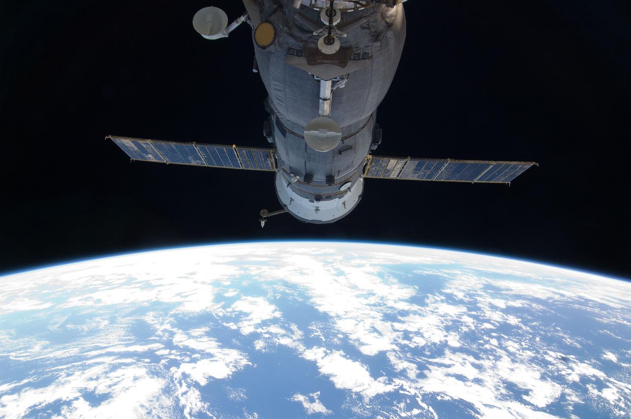 ISS029-E-005064 (16 Sept. 2011) --- Backdropped by Earth?s horizon and the blackness of space, a docked Russian Soyuz spacecraft is featured in this image photographed by an Expedition 29 crew member on the International Space Station.