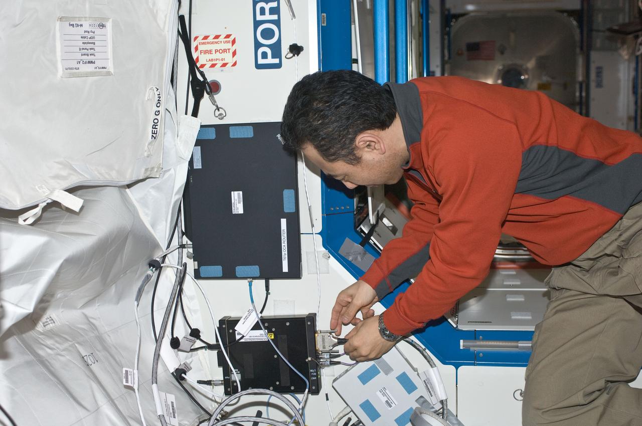 ISS029-E-007212 (21 Sept. 2011) --- Japan Aerospace Exploration Agency astronaut Satoshi Furukawa, Expedition 29 flight engineer, installs a new T61p laptop to replace the previous A31p as OCA Router in the Joint Station LAN/Local Area Network (JSL LAN). The laptop is located in the hatch area of the Destiny laboratory of the International Space Station.