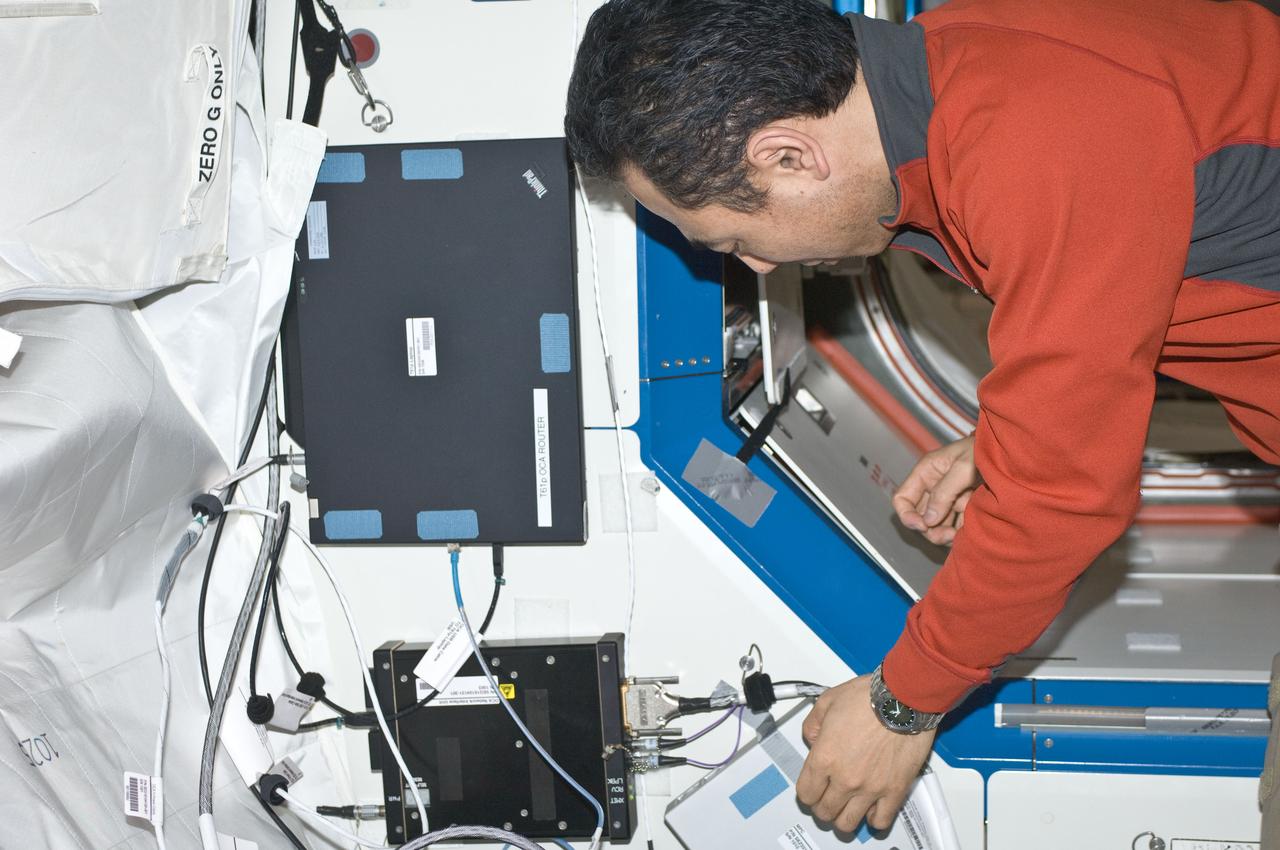 ISS029-E-007213 (21 Sept. 2011) --- Japan Aerospace Exploration Agency astronaut Satoshi Furukawa, Expedition 29 flight engineer, installs a new T61p laptop to replace the previous A31p as OCA Router in the Joint Station LAN/Local Area Network (JSL LAN). The laptop is located in the hatch area of the Destiny laboratory of the International Space Station.
