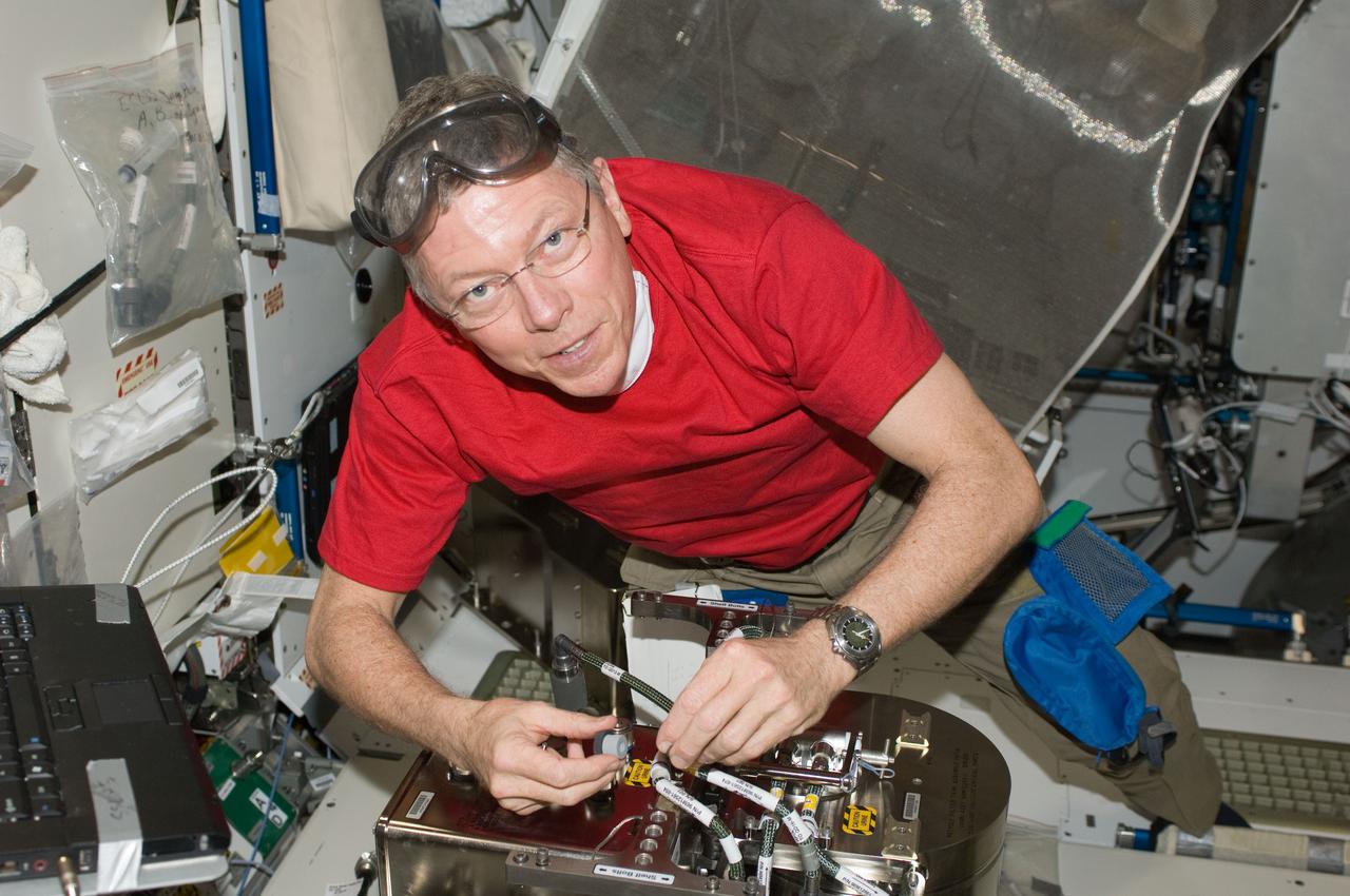 ISS029-E-007892 (23 Sept. 2011) --- NASA astronaut Mike Fossum, Expedition 29 commander, works with the Water Recovery System (WRS) Fluids Control and Pump Assembly (FCPA) in the Destiny laboratory of the International Space Station.
