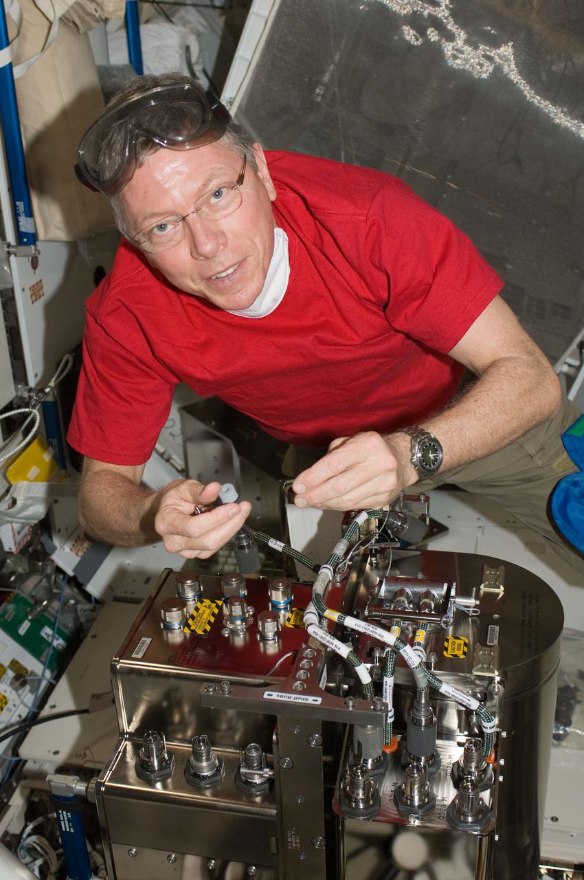 ISS029-E-007893 (23 Sept. 2011) --- NASA astronaut Mike Fossum, Expedition 29 commander, works with the Water Recovery System (WRS) Fluids Control and Pump Assembly (FCPA) in the Destiny laboratory of the International Space Station.