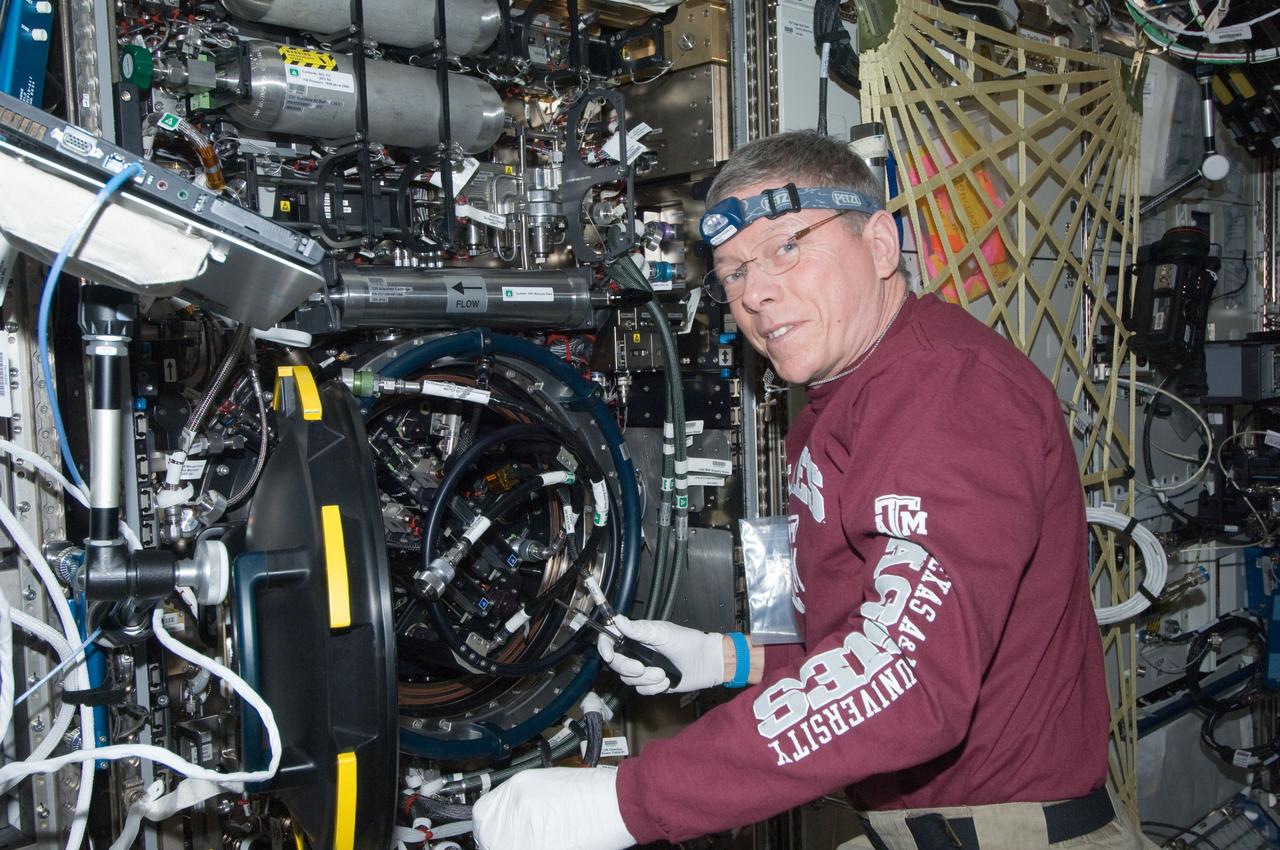 ISS029-E-008335 (22 Sept. 2011) --- NASA astronaut Mike Fossum, Expedition 29 commander, works with the Combustion Integrated Rack (CIR) Multi-user Drop Combustion Apparatus (MDCA) in the Destiny laboratory of the International Space Station.