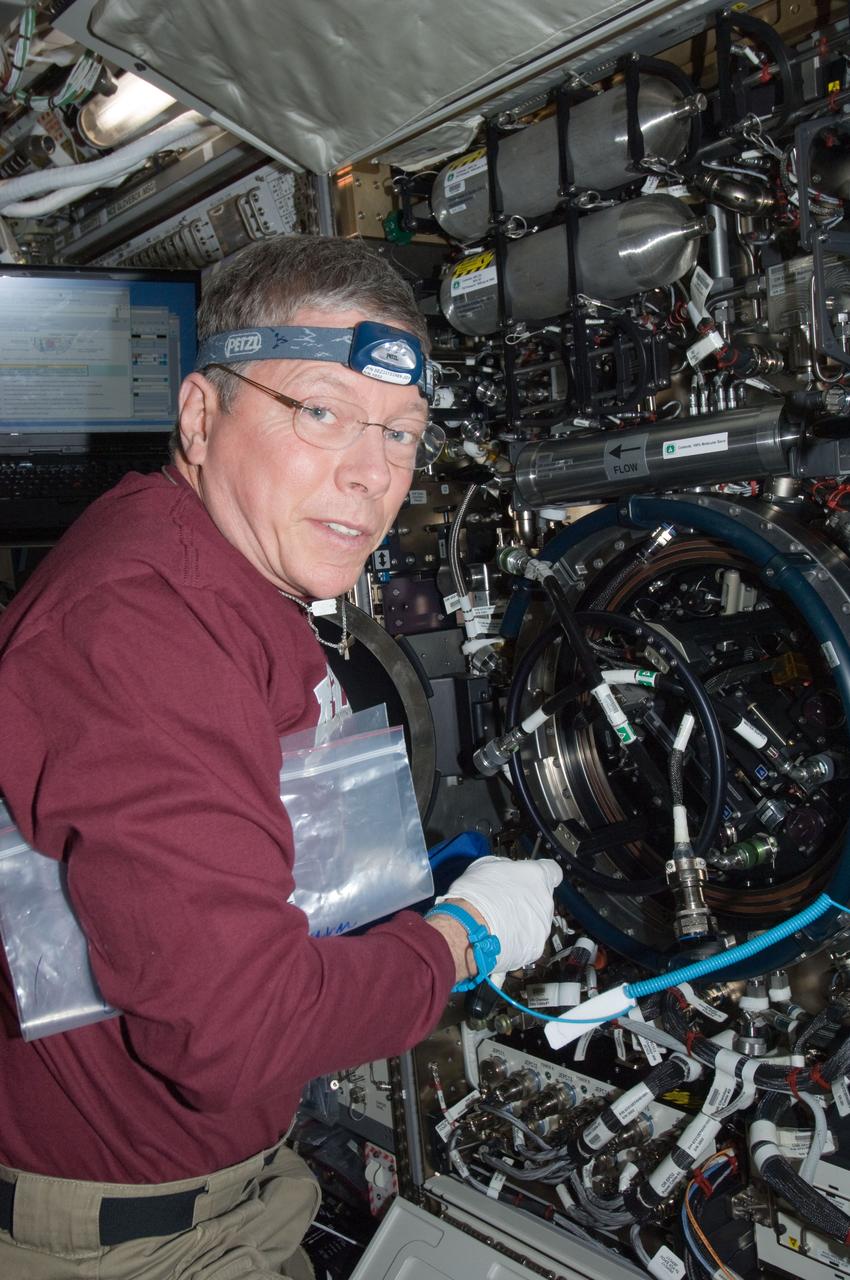 ISS029-E-008337 (22 Sept. 2011) --- NASA astronaut Mike Fossum, Expedition 29 commander, works with the Combustion Integrated Rack (CIR) Multi-user Drop Combustion Apparatus (MDCA) in the Destiny laboratory of the International Space Station.