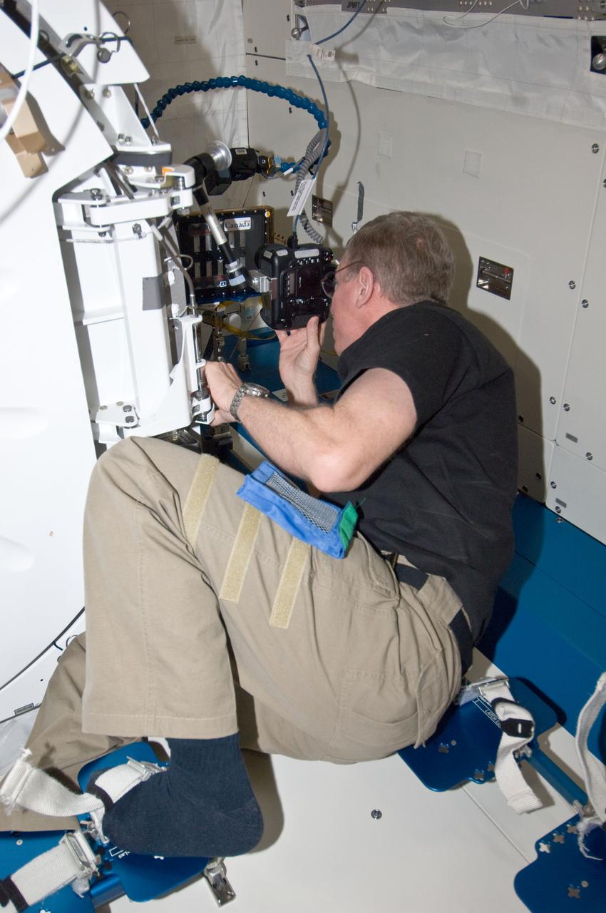 ISS029-E-010998 (21 Sept. 2011) --- NASA astronaut Mike Fossum, Expedition 29 commander, prepares a camcorder for recording documentary video of the Binary Colloidal Alloy Test-5 (BCAT-5) payload operations in the Kibo laboratory of the International Space Station.