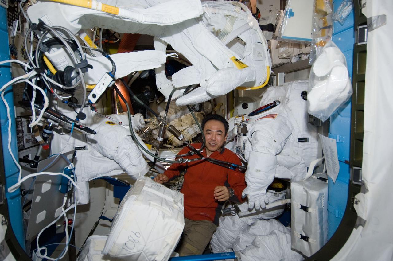 ISS029-E-011030 (26 Sept. 2011) --- Japan Aerospace Exploration Agency astronaut Satoshi Furukawa, Expedition 29 flight engineer, performs protective maintenance on Extravehicular Mobility Unit (EMU) spacesuits in the Quest airlock of the International Space Station.