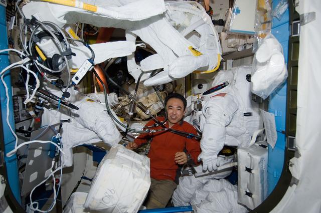 NASA image: Furukawa in airlock performing protective maintenance on EMUs