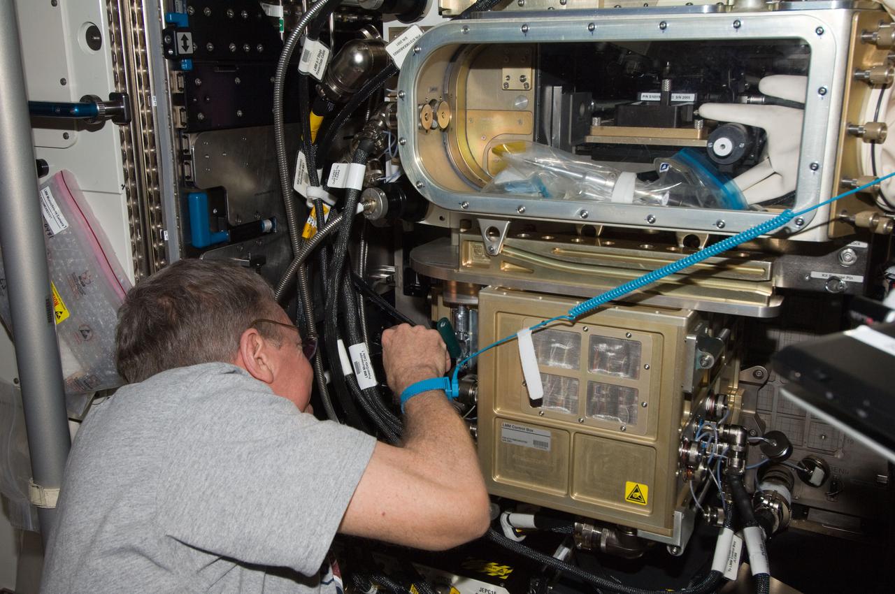 ISS029-E-011867 (29 Sept. 2011) --- NASA astronaut Mike Fossum, Expedition 29 commander, works with the Light Microscopy Module (LMM) control box in the Destiny laboratory of the International Space Station in preparation for another session with the Preliminary Advanced Colloids Experiment (PACE) hardware.