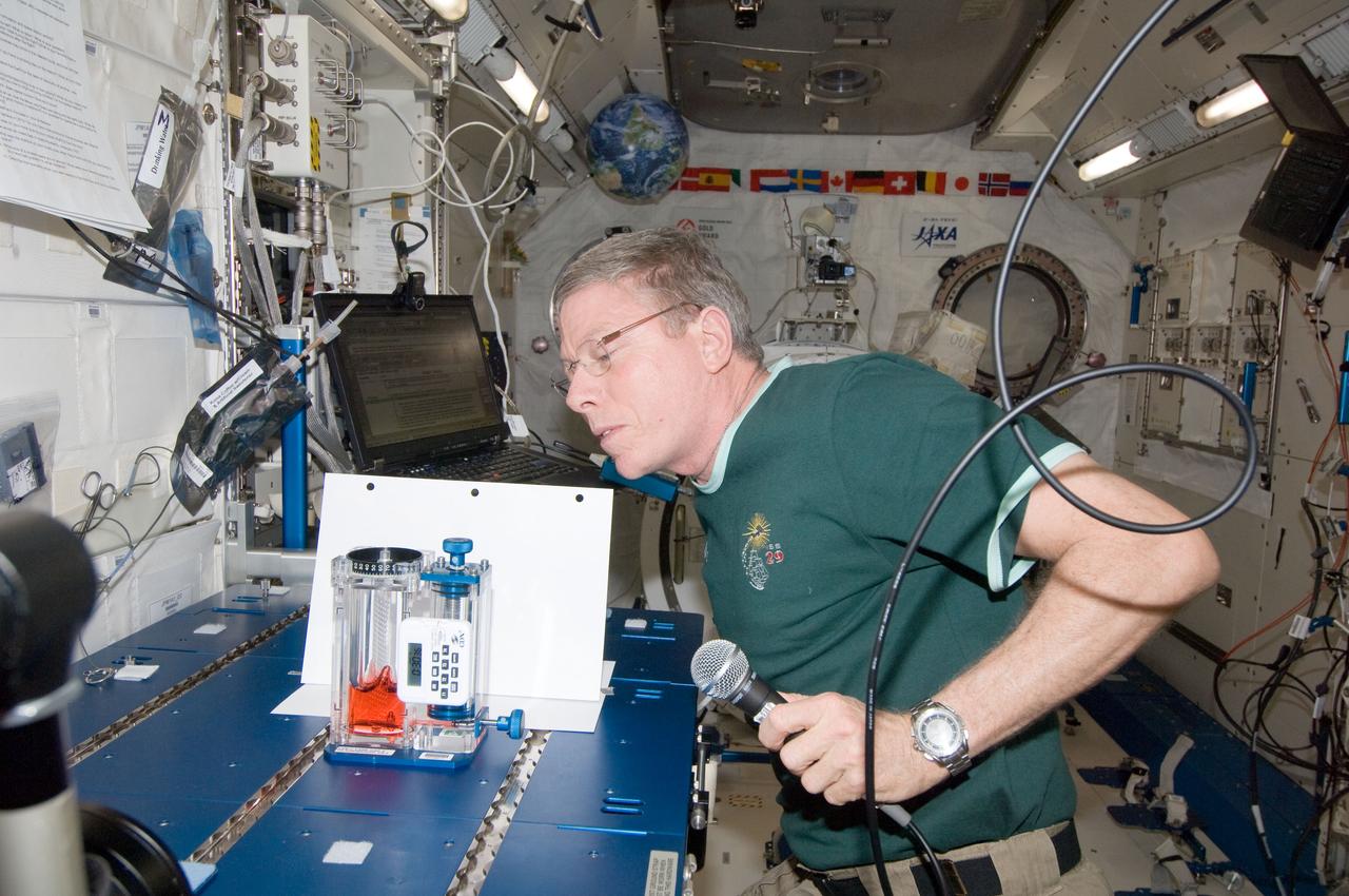 ISS029-E-015119 (30 Sept. 2011) --- NASA astronaut Mike Fossum, Expedition 29 commander, conducts a session with the Capillary Flow Experiment (CFE) Vane Gap-2 (VG2) in the Kibo laboratory of the International Space Station. CFE observes the flow of fluid, in particular capillary phenomena, in microgravity.