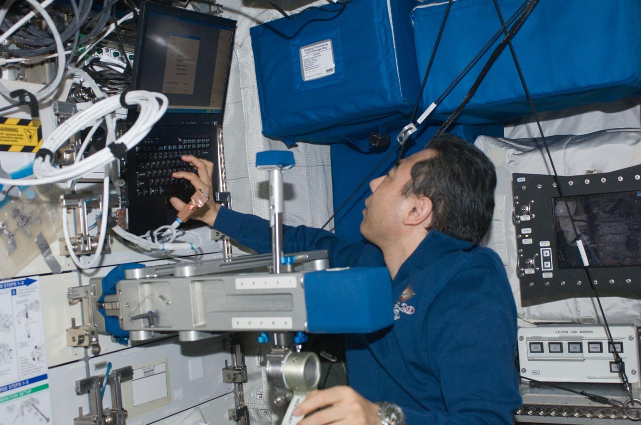 ISS029-E-017474 (5 Oct. 2011) --- Japan Aerospace Exploration Agency astronaut Satoshi Furukawa, Expedition 29 flight engineer, prepares to use the Space Linear Acceleration Mass Measurement Device (SLAMMD) in the Columbus laboratory of the International Space Station.