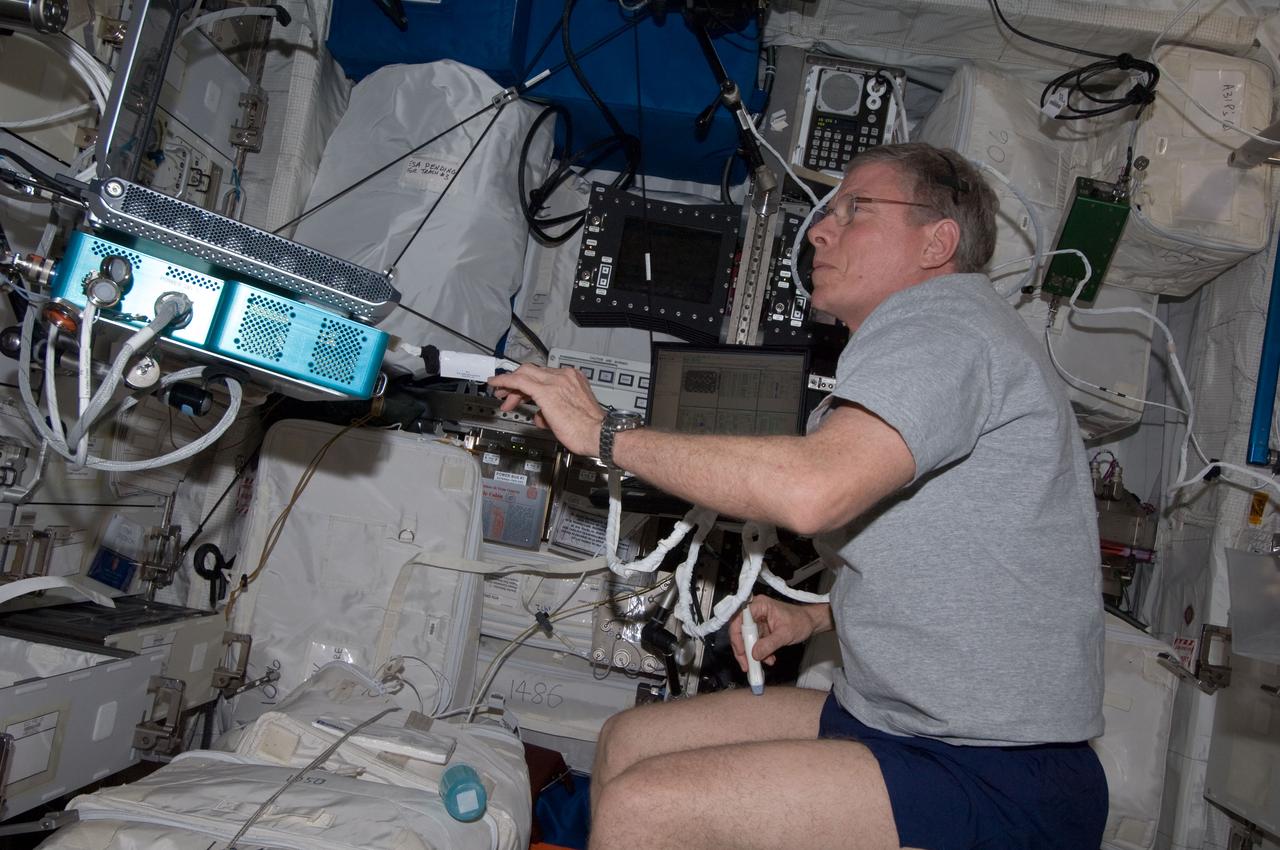 ISS029-E-025270 (3 Oct. 2011) --- NASA astronaut Mike Fossum, Expedition 29 commander, performs a SPRINT leg muscle self scan in the Columbus laboratory of the International Space Station. Fossum powered on the Ultrasound 2 (USND-2) unit and Video Power Converter (VPC) hardware, and connected the VPC to Human Research Facility 1 (HRF-1) in order to perform this activity.