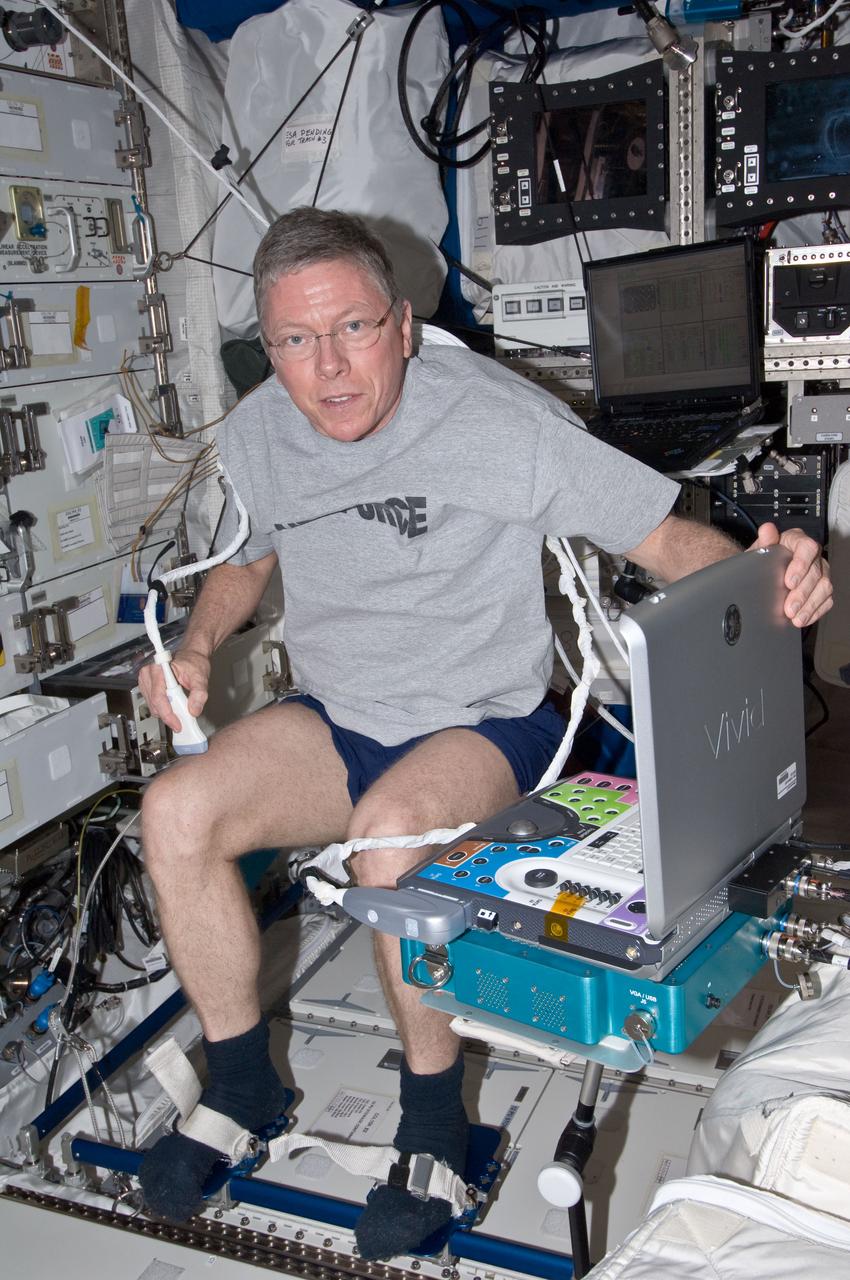 ISS029-E-025280 (3 Oct. 2011) --- NASA astronaut Mike Fossum, Expedition 29 commander, performs a SPRINT leg muscle self scan in the Columbus laboratory of the International Space Station. Fossum powered on the Ultrasound 2 (USND-2) unit and Video Power Converter (VPC) hardware, and connected the VPC to Human Research Facility 1 (HRF-1) in order to perform this activity.