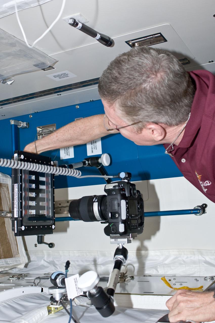 ISS029-E-032414 (24 Oct. 2011) --- NASA Mike Fossum, Expedition 29 commander, conducts a session with the Binary Colloidal Alloy Test-6 (BCAT-6) experiment in the Kibo laboratory of the International Space Station.