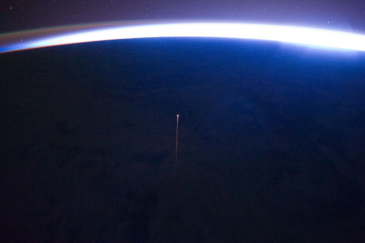 ISS029-E-034092 (29 Oct. 2011) --- This unusual photograph, captured by one of the Expedition 29 crew members aboard the International Space Station, highlights the reentry plasma trail (center) of  Progress 42P (M-10M) supply vehicle. Progress 42P docked at the space station on April 29, 2011, and was undocked and de-orbited approximately 183 days later on Oct. 29, 2011. The ISS was located over the southern Pacific Ocean when this image was taken. Light from the rising sun illuminates the curvature of the Earth limb (horizon line) at top, but does not completely overwhelm the airglow visible at image top left. Airglow is caused by light emitted at specific wavelengths by atoms and molecules excited by ultraviolet radiation in the upper atmosphere.