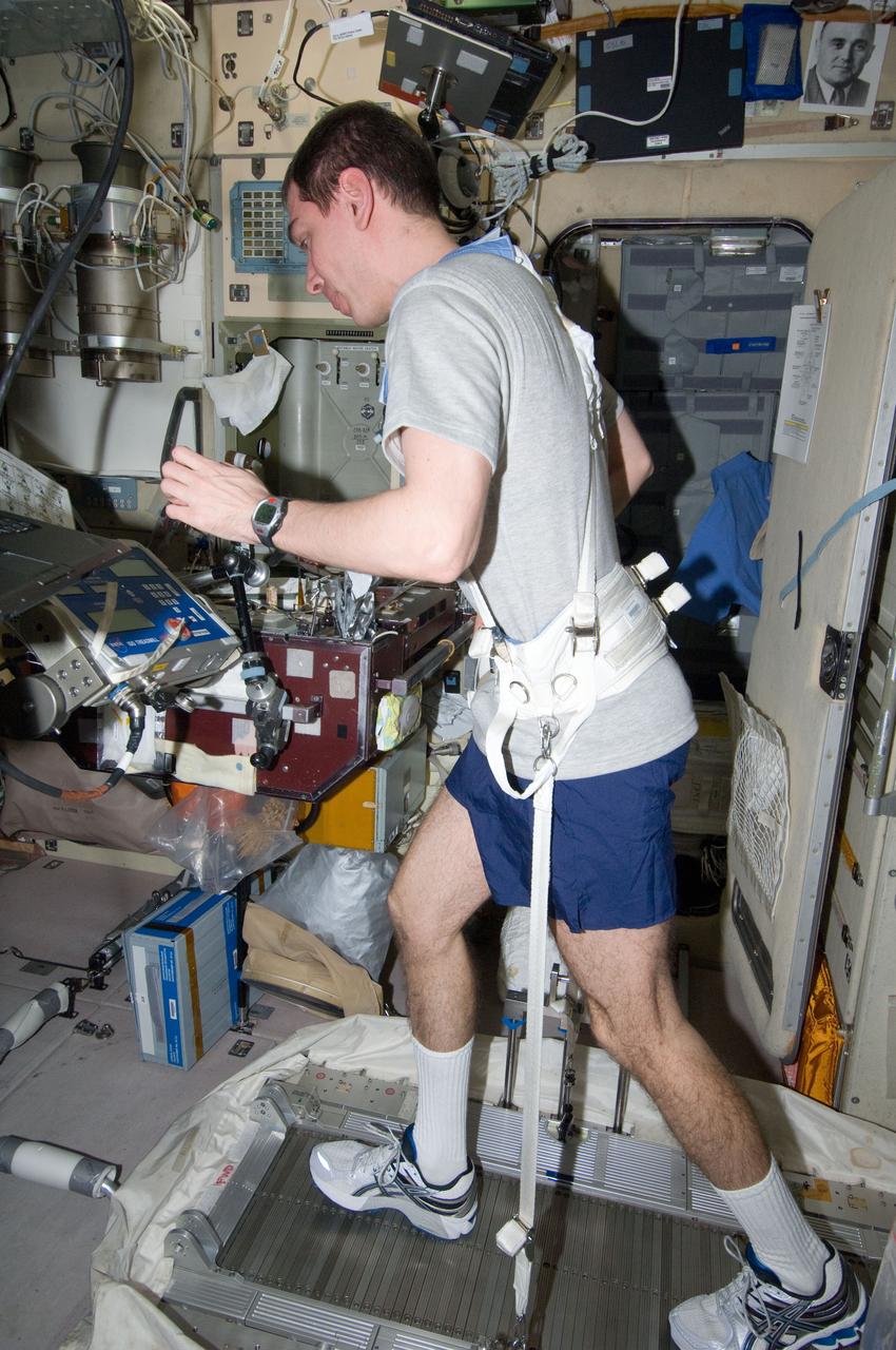 ISS029-E-040701 (8 Nov. 2011) --- Russian cosmonaut Sergei Volkov, Expedition 29 flight engineer, equipped with a bungee harness, exercises on the Treadmill Vibration Isolation System (TVIS) in the Zvezda Service Module of the International Space Station.