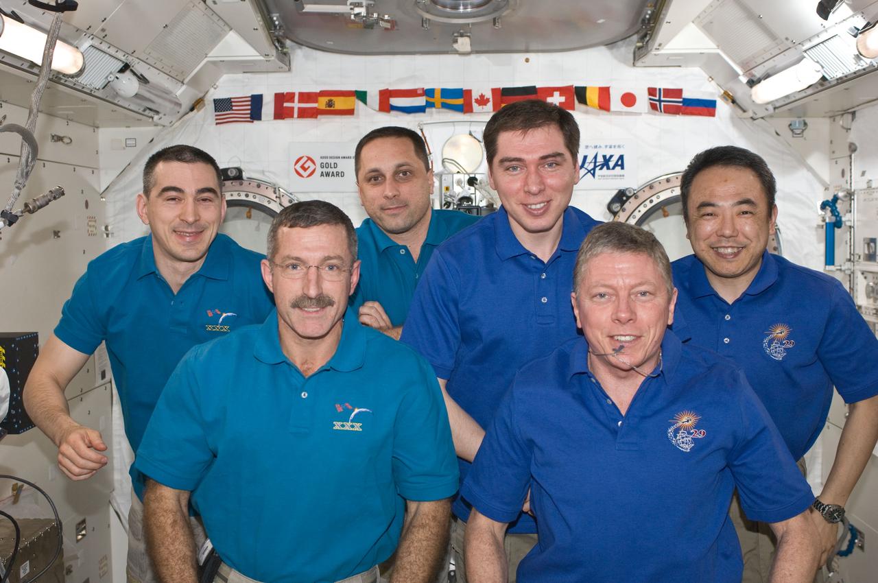 ISS029-E-043133 (20 Nov. 2011) --- Expedition 28/29 and Expedition 29/30 crew members pose for a group portrait in the International Space Station?s Kibo laboratory following the ceremony of Changing-of-Command from Expedition 29 to Expedition 30. Pictured on the front row are NASA astronauts Dan Burbank (left), Expedition 30 commander; and Mike Fossum, Expedition 29 commander. Pictured from the left (back row) are Russian cosmonauts Anatoly Ivanishin, and Anton Shkaplerov, both Expedition 30 flight engineers; and Sergei Volkov, Expedition 29 flight engineer; along with Japan Aerospace Exploration Agency astronaut Satoshi Furukawa, Expedition 29 flight engineer.