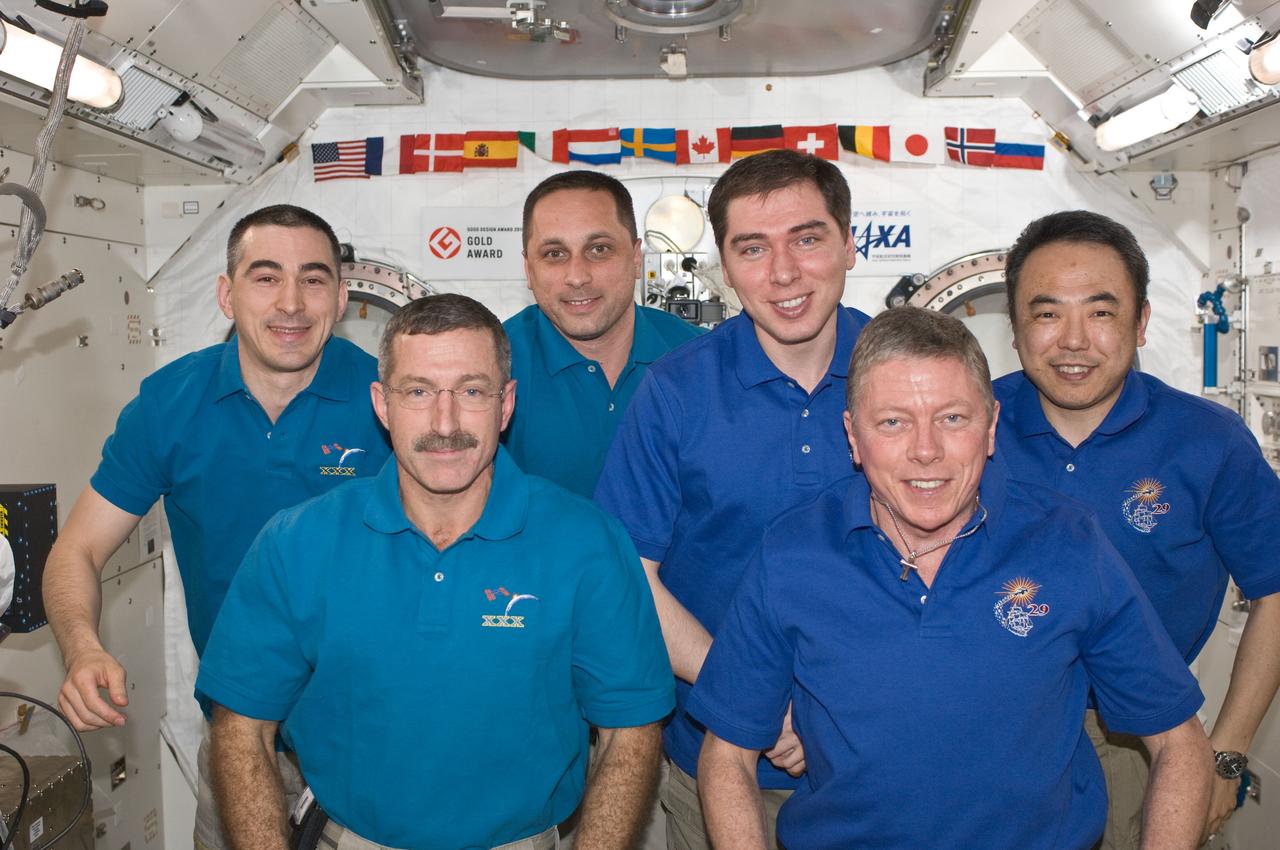 ISS029-E-043136 (20 Nov. 2011) --- Expedition 28/29 and Expedition 29/30 crew members pose for a group portrait in the International Space Station?s Kibo laboratory following the ceremony of Changing-of-Command from Expedition 29 to Expedition 30. Pictured on the front row are NASA astronauts Dan Burbank (left), Expedition 30 commander; and Mike Fossum, Expedition 29 commander. Pictured from the left (back row) are Russian cosmonauts Anatoly Ivanishin, and Anton Shkaplerov, both Expedition 30 flight engineers; and Sergei Volkov, Expedition 29 flight engineer; along with Japan Aerospace Exploration Agency astronaut Satoshi Furukawa, Expedition 29 flight engineer.