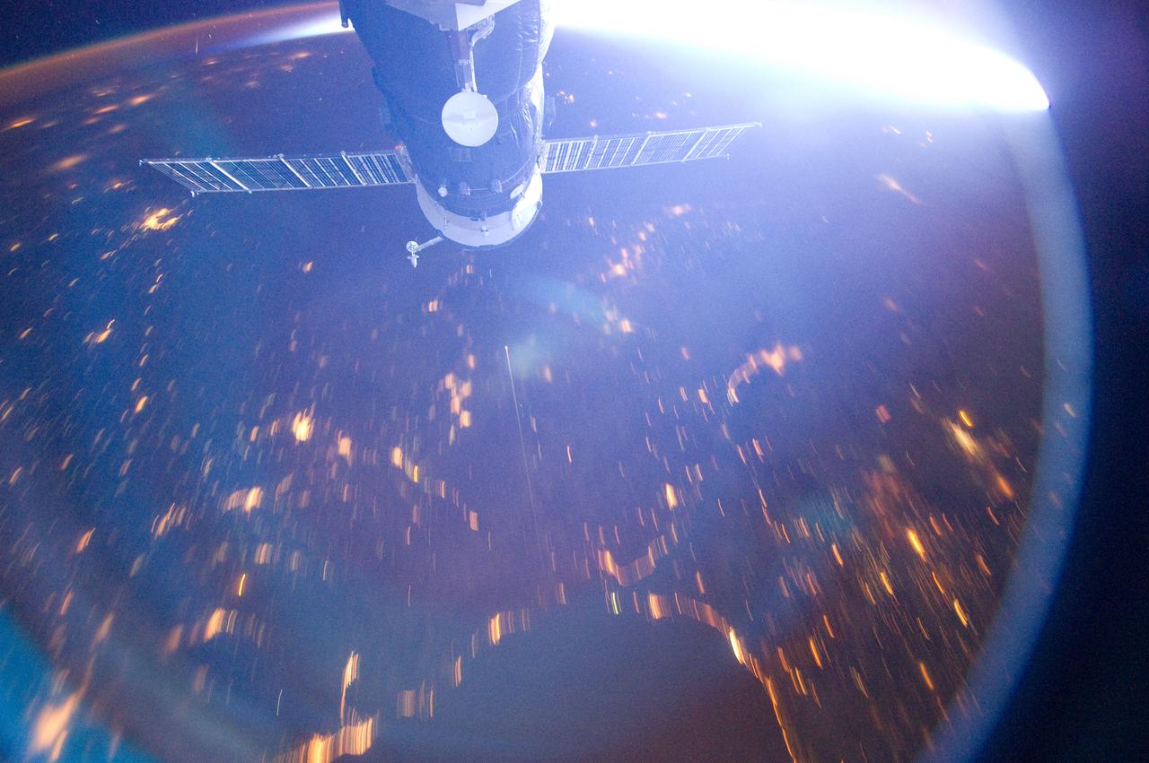 ISS030-E-005757 (22 Nov. 2011) --- This  photograph, taken from the International Space Station flying approximately 220 miles above Earth, was captured by NASA astronaut Dan Burbank, Expedition 30  commander, as he visually followed the course of the Soyuz spacecraft carrying the Expedition 29 threesome of Mike Fossum, Satoshi Furukawa and Sergei Volkov toward their entry through the atmosphere.  According to a Twitter message from Burbank, the Soyuz appears as a tiny streak near the exact center of the image. The orbital outpost was over a point near the southeastern Black Sea (bottom) looking generally northeastward over southern Russia/eastern Ukraine. A Russian Progress spacecraft, docked to the station, appears at the top of the frame.