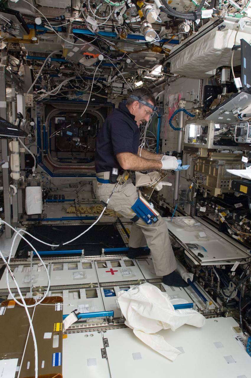 ISS030-E-007419 (1 Dec. 2011) --- In the International Space Station’s Destiny laboratory, NASA astronaut Dan Burbank, Expedition 30 commander, conducts a session with the Preliminary Advanced Colloids Experiment (PACE) at the Light Microscopy Module (LMM) in the Fluids Integrated Rack / Fluids Combustion Facility (FIR/FCF). PACE is designed to investigate the capability of conducting high magnification colloid experiments with the LMM for determining the minimum size particles which can be resolved with it.