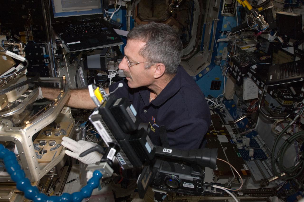 ISS030-E-007429 (1 Dec. 2011) --- NASA astronaut Dan Burbank, Expedition 30 commander, works at the Light Microscopy Module (LMM) in the Fluids Integrated Rack / Fluids Combustion Facility (FIR/FCF) located in the Destiny laboratory of the International Space Station.