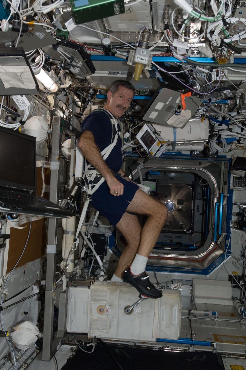 ISS030-E-010644 (9 Dec. 2011) --- NASA astronaut Dan Burbank, Expedition 30 commander, exercises on the Cycle Ergometer with Vibration Isolation System (CEVIS) in the Destiny laboratory of the International Space Station.