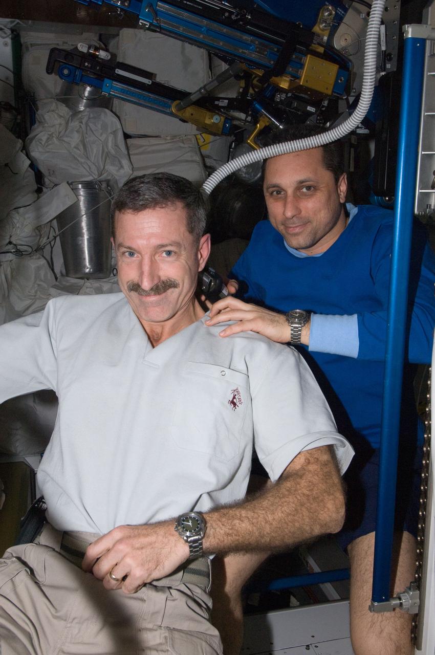 ISS030-E-012655 (18 Dec. 2011) --- Russian cosmonaut Anton Shkaplerov, Expedition 30 flight engineer, trims the hair of NASA astronaut Dan Burbank, commander, in the Tranquility node of the International Space Station. Shkaplerov used hair clippers fashioned with a vacuum device to garner freshly cut hair.