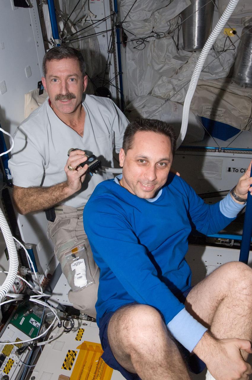 ISS030-E-012660 (18 Dec. 2011) --- NASA astronaut Dan Burbank, Expedition 30 commander, trims the hair of Russian cosmonaut Anton Shkaplerov, flight engineer, in the Tranquility node of the International Space Station. Burbank used hair clippers fashioned with a vacuum device to garner freshly cut hair.