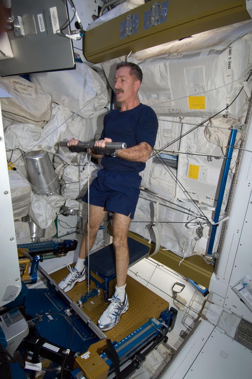 ISS030-E-012727 (18 Dec. 2011) --- NASA astronaut Dan Burbank, Expedition 30 commander, uses the short bar for the advanced Resistive Exercise Device (aRED) equipment to perform upper body strengthening pull-ups in the Tranquility node of the International Space Station.